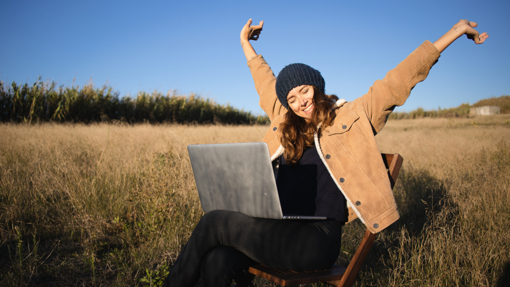 Mujer con el portatil en el campo